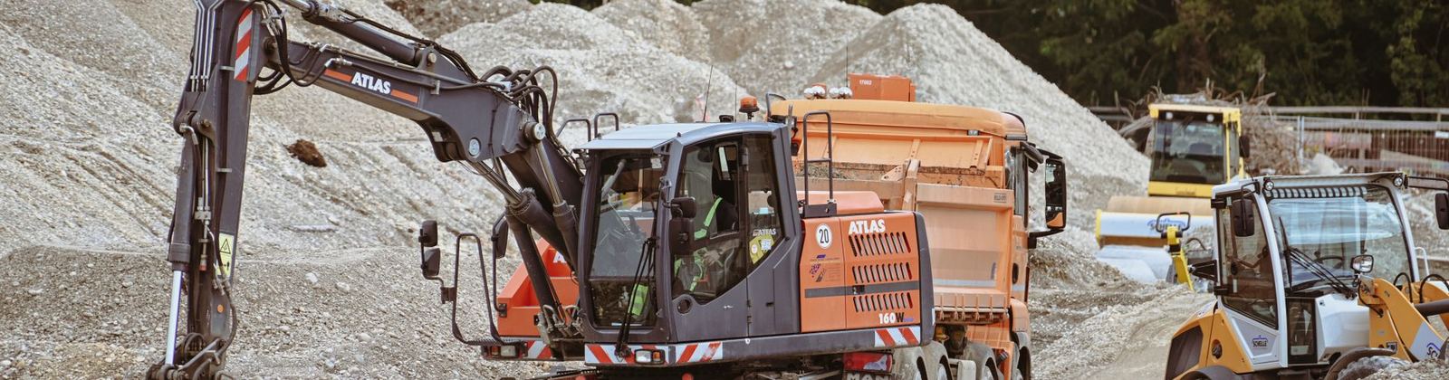An excavator and loaders working on a construction site