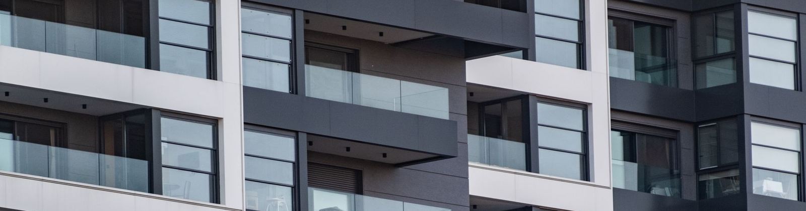 A contemporary apartment building with glass balconies